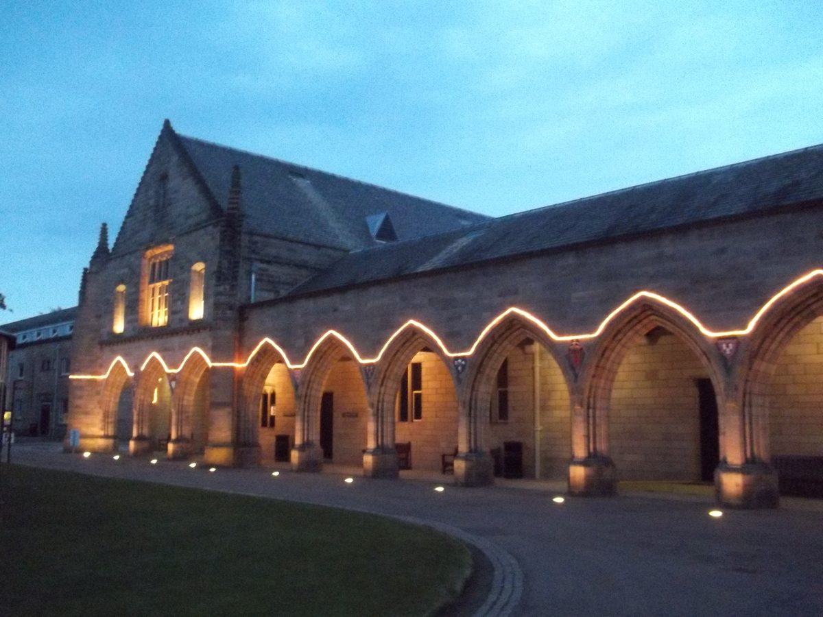 Elphinstone Hall at King's College, its arcade lit at dusk